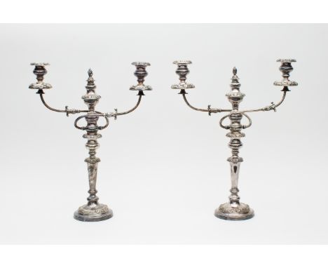 A pair of silver plated two-branch three-light candelabra, the central sconce with flame finial attachment to two reeded scro