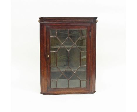 A George III mahogany corner cupboard, the astragal glazed panel door enclosing shelves, 100.5cm high and three chairs