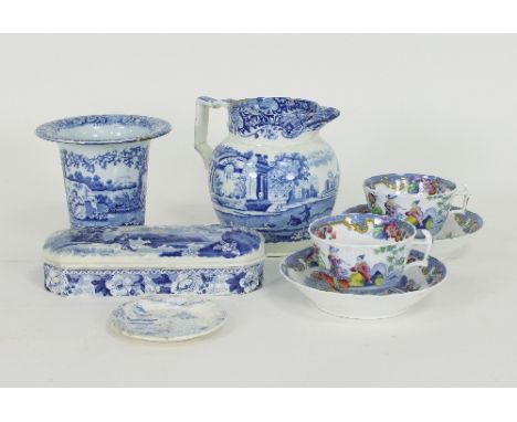 A Staffordshire blue and white toothbrush box and cover, a vase with flanged top, a jug, two cups and saucers and a small dis