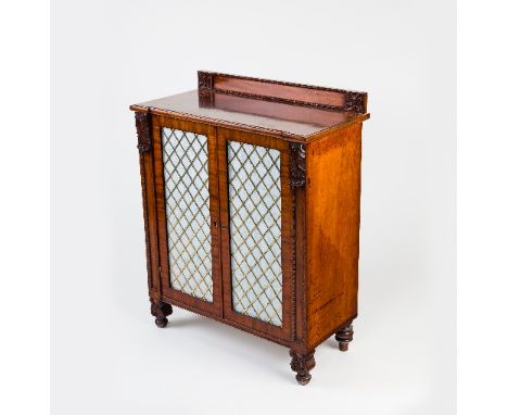 A Regency mahogany cupboard, the back with knulled border and flowerheads to each end, applied acanthus moulding and fielded 