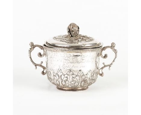 A late 17th Century silver porringer and cover, maker's mark IS, London 1693, the cover with bud finial, the cup with band of