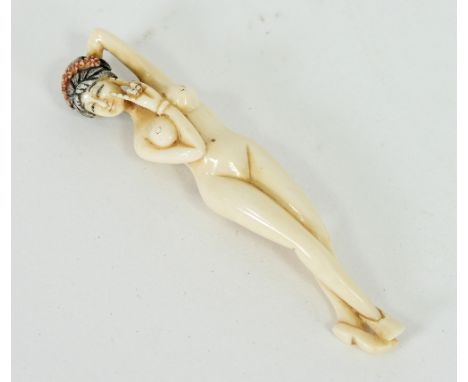 A Japanese ivory netsuke carved as a female nude, indistinctly signed