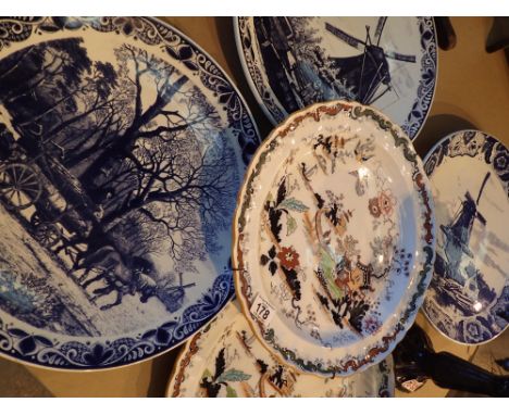 Five large ceramic charger plates including Delft and Ashworth 