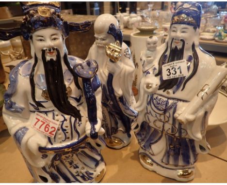 Three blue and white ceramic Oriental figurines