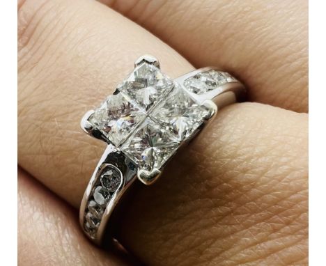 An 18ct white gold 1ct diamond cluster ring. Featuring a central square cluster of four invisible set princess cut diamonds, 