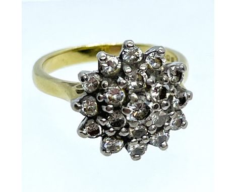 A diamond and 18ct yellow gold cluster ring. An estimated combined diamond weight of approximately 0.60 cts. Central stone wi