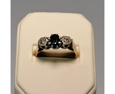 A diamond and sapphire three stone ring in 9ct gold. Size M. Approximate weight 3.4 grams.