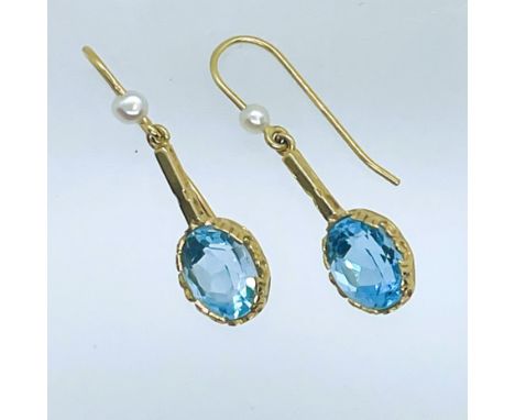 A collection of earrings. Featuring a pair of hallmarked 9ct gold Swiss blue topaz and cultured pearl ear drops on shepherd's