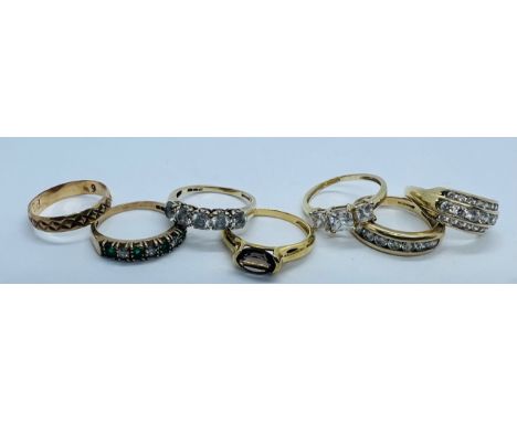 A collection of 14ct and 9ct gold jewellery. Featuring four 14ct gold rings set with cubic zirconia, an oval smoky quartz 14c