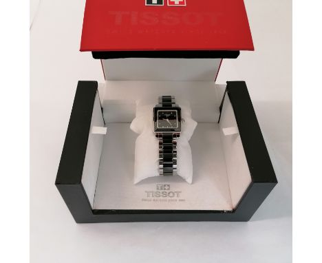 A diamond set Tissot Cera ladies wristwatch. Featuring a square dial and bezel and a black ceramic and stainless steel bracel