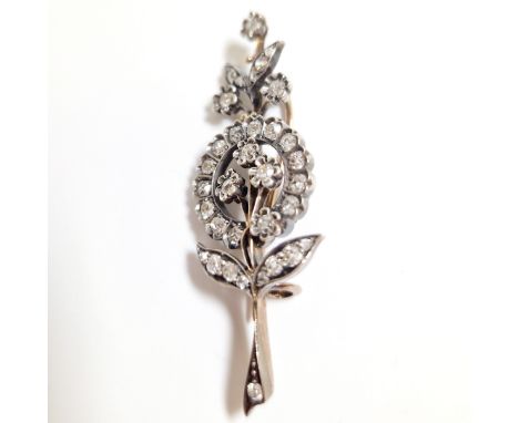 An diamond Belle Epoque spray brooch featuring old mine cut and rose cut diamonds. Constructed in yellow and white metal, wit