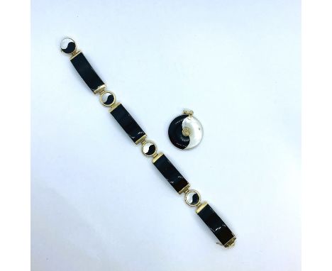 An onyx and mother of pearl yin and yang bracelet in 14ct gold along with a yellow metal and matching pendant.&nbsp;