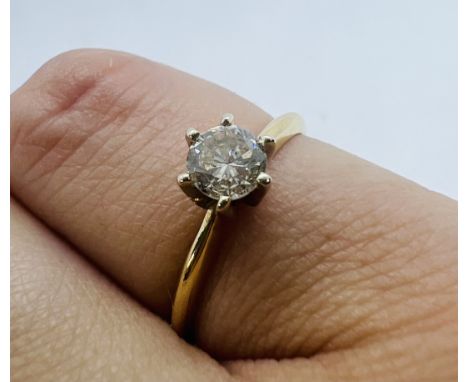 A diamond solitaire ring, featuring an estimated 0.33 carat central stone on a yellow metal claw setting. Shank stamped "14K"
