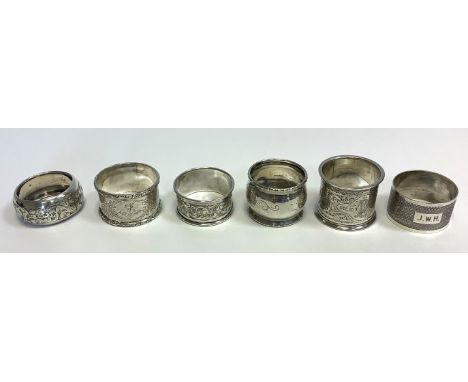 5  silver napkin holders to include:  - 1 marked for Birmingham 1921; maker John Rose; engraved with the letter 'L', 4.5cms b