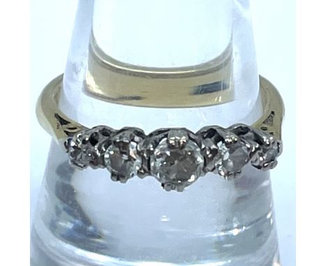 A graduated five-stone diamond half hoop ring in 18ct gold. Featuring the commemorative millennium hallmark.&nbsp;Estimated t