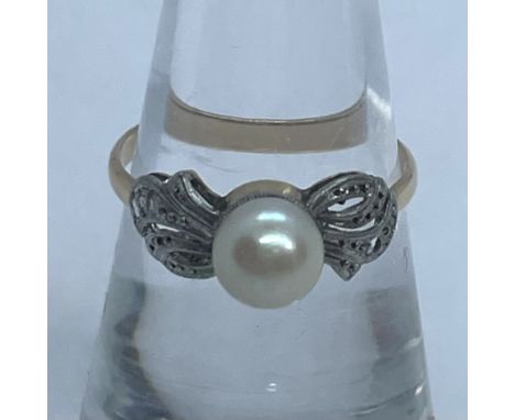 A circa 1920s cultured pearl and three-facet rose cut diamond dress ring. In unmarked yellow metal. Surface testing in the re
