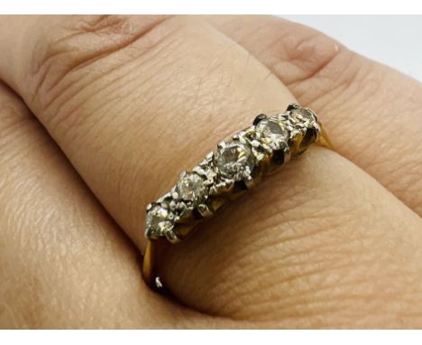 An early 20th century five stone diamond ring. Shank stamped "18ct &amp; Plat". Size P. Estimated total diamond weight 0.20 c