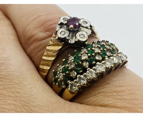 A collection of three 9ct gold gems et dress rings. To include a 9ct gold emerald and diamond dress ring featuring three rows