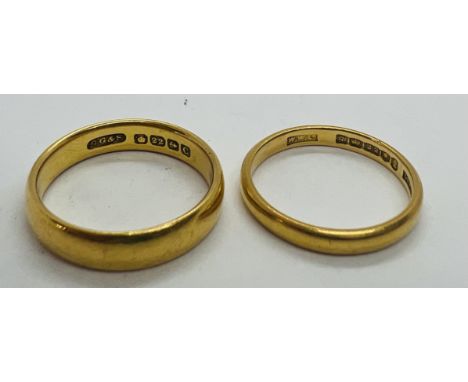 Two 22ct gold wedding rings, one size K, approximately 2.48 grams, and one size L 1/2, approximately 4.6 grams.