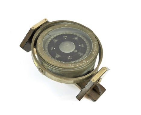 GIMBAL COMPASS. A naval brass gimbal compass with crows foot arrow & No. 3153.H.S. Now mounted on a wooden stand decorated wi