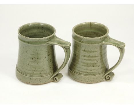 LEACH POTTERY. Two celadon glazed Leach Pottery Standard Ware pint tankards. Pottery marks.  Please note that all items in th