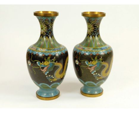 CLOISONNE. A pair of Chinese cloisonne vases, enamelled with yellow dragons chasing a pearl on a black ground. Height 23.5cm.