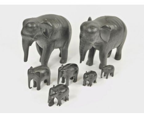 EBONY ELEPHANTS. Two large carved ebony elephants (lack tusks & some trunk damage). Height 16cm. Also, five smaller ebony ele
