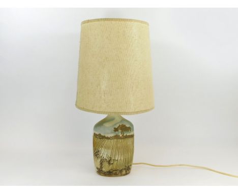 TREMAEN POTTERY. A Tremaen Pottery, Newlyn, ploughed field landscape lamp base with original shade. Height including shade 60