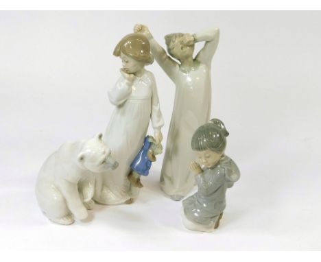 LLADRO & NAO ETC. A Lladro yawning boy figure & a Lladro seated polar bear. Also, two Nao figures.  Please note that all item