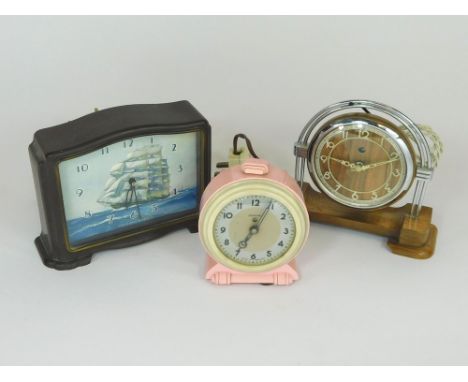 ELECTRIC CLOCKS. Three electric clocks including a pink Ferranti, a Smith's Sailing Ship in bakelite case & a wooden & chrome