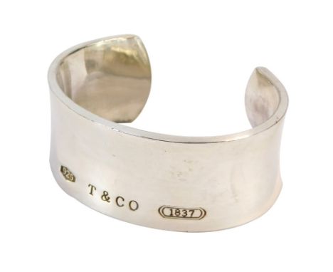 A cuff bangle, in the Tiffany &amp; Co style stamped 925 T &amp; Co 1837, and to interior dated 1997, 6cm diameter with inver
