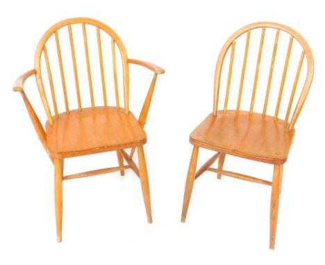 Two Ercol pine stick back kitchen chairs, to include one carver.