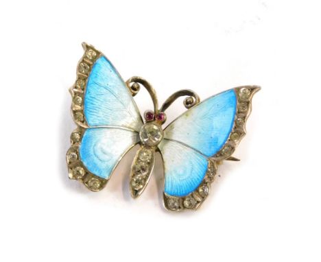 An enamel butterfly brooch, the blue and white enamelled winged butterfly with paste stone set body and wings, white metal st