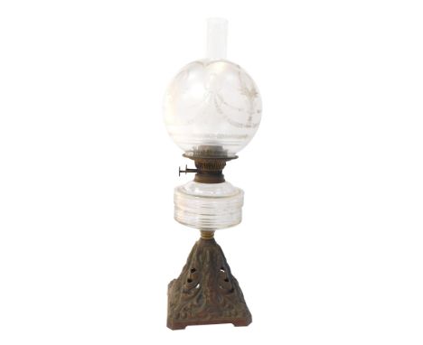 An Art Nouveau brass oil lamp, the domed and etched floral shade, on a ribbed reservoir, on an Art Nouveau scroll design squa