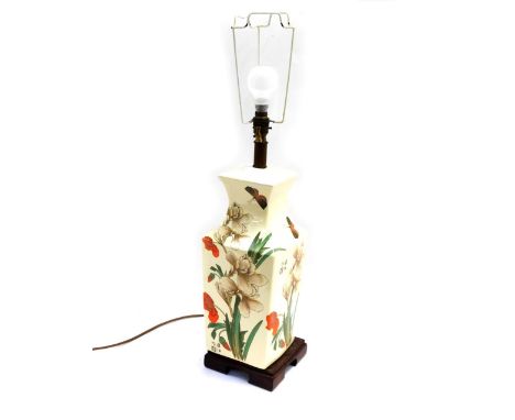 An Oriental ceramic table lamp, with painted detailing of red and white flowers, with butterflies and four character mark on 