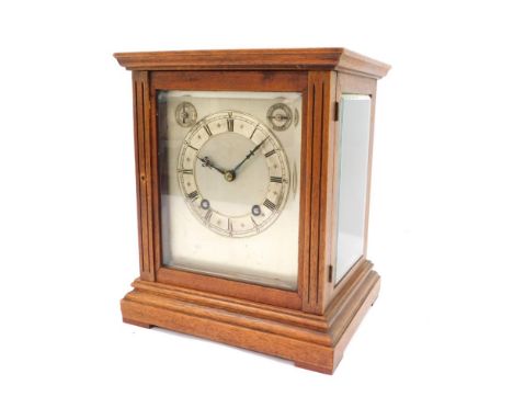 An early 20thC mahogany cased mantel clock, with silver coloured Roman numeric dial, twenty one day movement with chime and s