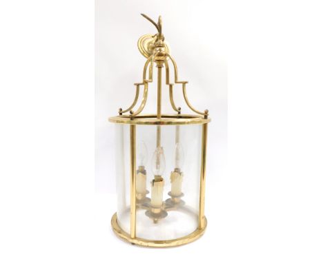 An early 20thC brass lantern, with arched top and three branch candelabrum interior, with four glass sections, 56cm high befo