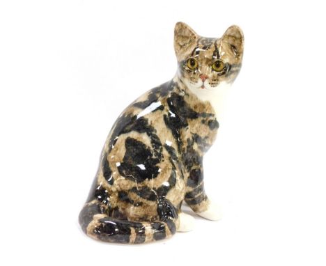 A Winstanley ceramic cat, with applied glass eyes, bearing signature to underside, 25cm high.