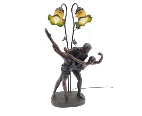 After Trossi. A cast bronzed finish dancers table lamp, with two ballet dancers in embrace, the green glass arched shades on 