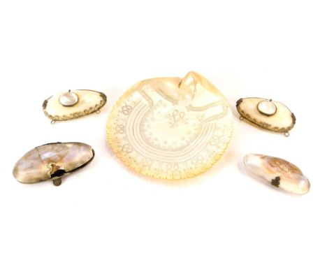 A group of mother of pearl items, comprising a carved mother of pearl clam shell, 16cm diameter, and four various mother of p