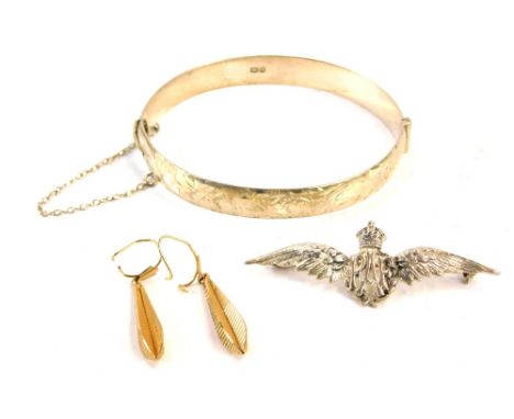 A small group of jewellery, comprising a silver RAF wings brooch, 6cm wide, a silver hinged bangle, with half floral design, 