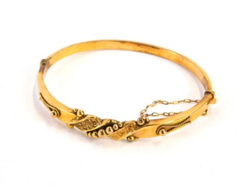 A Victorian hinged bangle, the central hammered ball and rope design, with safety chain, yellow metal stamped 9ct, 5.8g, 6cm 