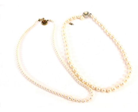 Two cultured pearl necklaces, comprising a single graduated strand necklace with 9ct gold clasp set with topaz, 47cm long ove
