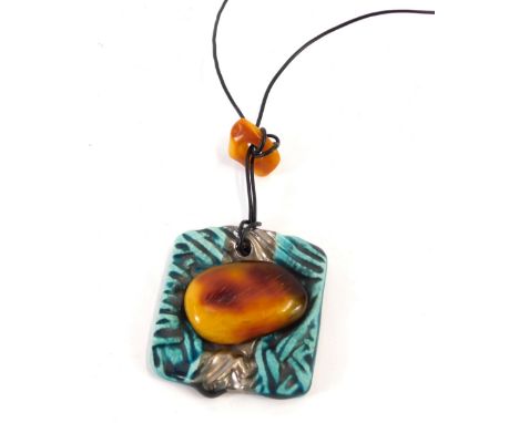 A Basia Lorpek ceramic and amber necklace, the ceramic panel with blue glazed outer detailing and a platinum overlaid central