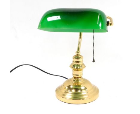 A brass desk lamp, with shaped green glass shade, 33cm high.