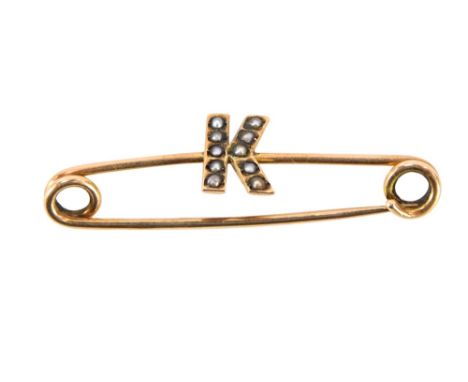A 9ct gold pin badge, bearing the emblem K, set with seed pearls, 4cm wide, 1.1g all in, in Knight &amp; Son box.