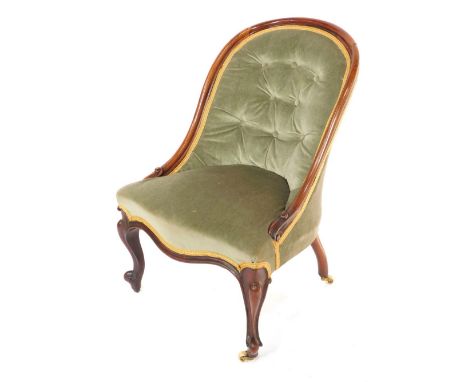 A Victorian rosewood spoon back nursing chair, upholstered in button back over stuffed green draylon, raised on cabriole legs