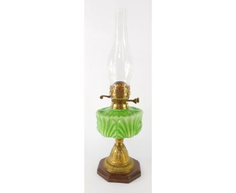 A Victorian brass and green glass oil lamp, with applied Art Nouveau brass leaf, and a green leaf reservoir and chimney, 55cm