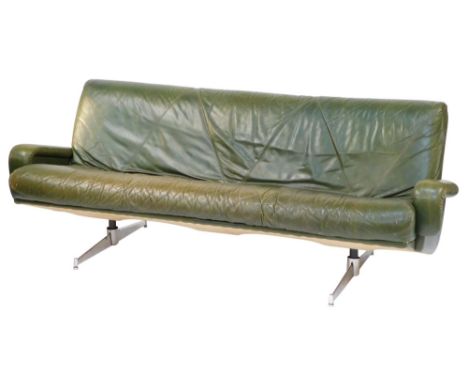 A 1960's vintage green leather three seater sofa, raised on twin chrome plated and cast iron supports, 202cm wide.