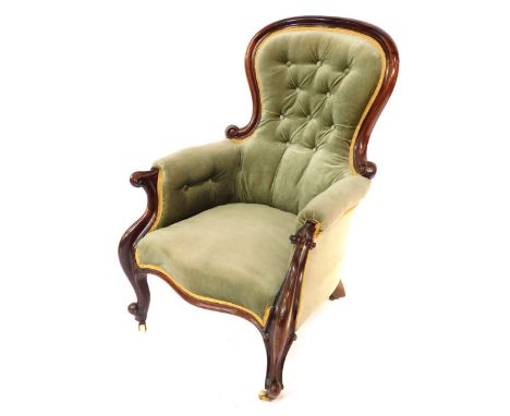 A Victorian mahogany spoon back armchair, the shield back with button detailing, 102cm high, 68cm wide, 60cm deep.